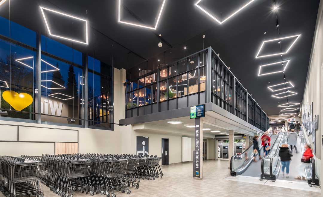 Two-storey entrance area illuminated with Lorino Square.