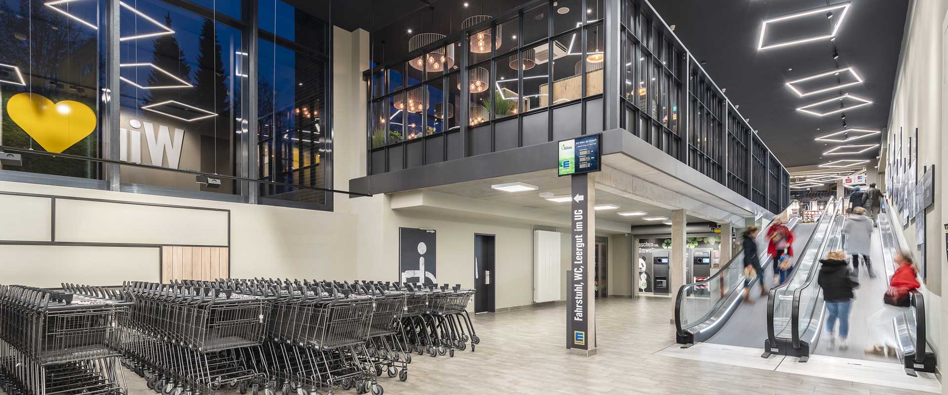 Two-storey entrance area illuminated with Lorino Square.